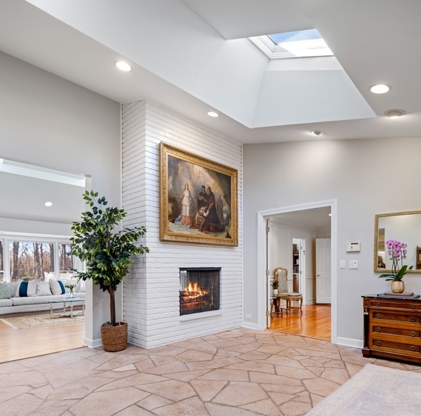 48 Meadowview Road Northfield, IL 60093 - Photo 3 of 42 a view of a hallway with a potted plant and a fireplace