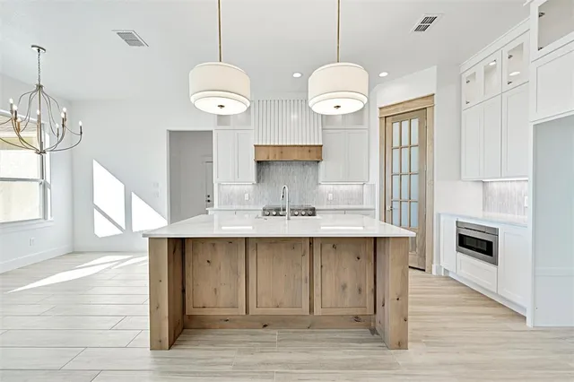 a view of a kitchen with a sink and wooden floor