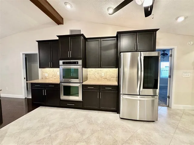 a kitchen with stainless steel appliances kitchen island granite countertop wooden cabinets and stainless steel appliances