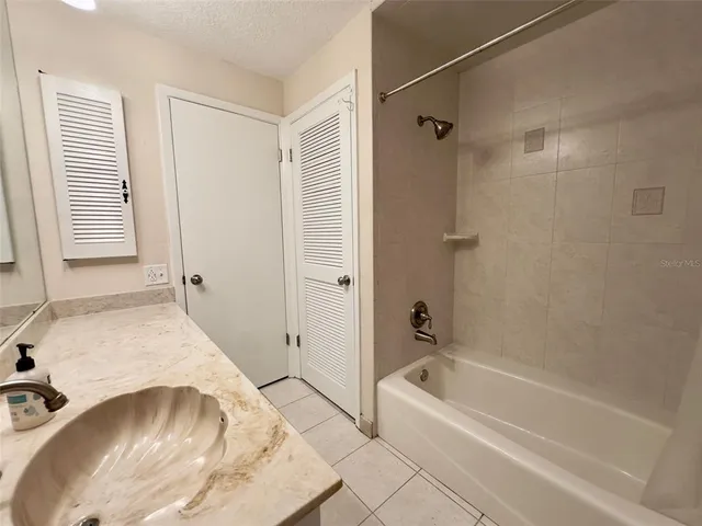 a bathroom with a tub and shower