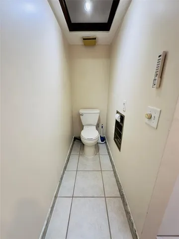 a bathroom with a white toilet and a shower