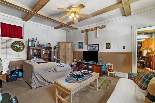 a kitchen with stainless steel appliances granite countertop a stove top oven a sink a dining table and chairs