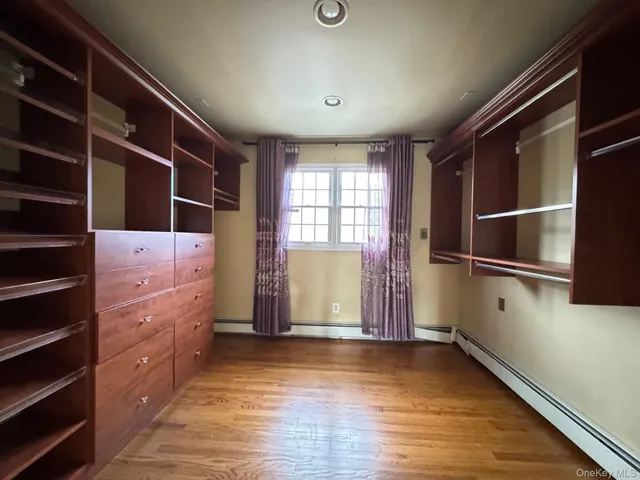 a view of walk in closet with clothes and shoes