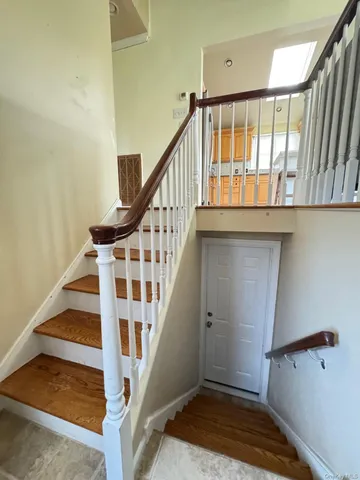 a view of staircase with white walls and a window