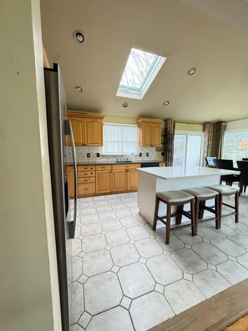 a kitchen with stainless steel appliances kitchen island granite countertop a sink and cabinets