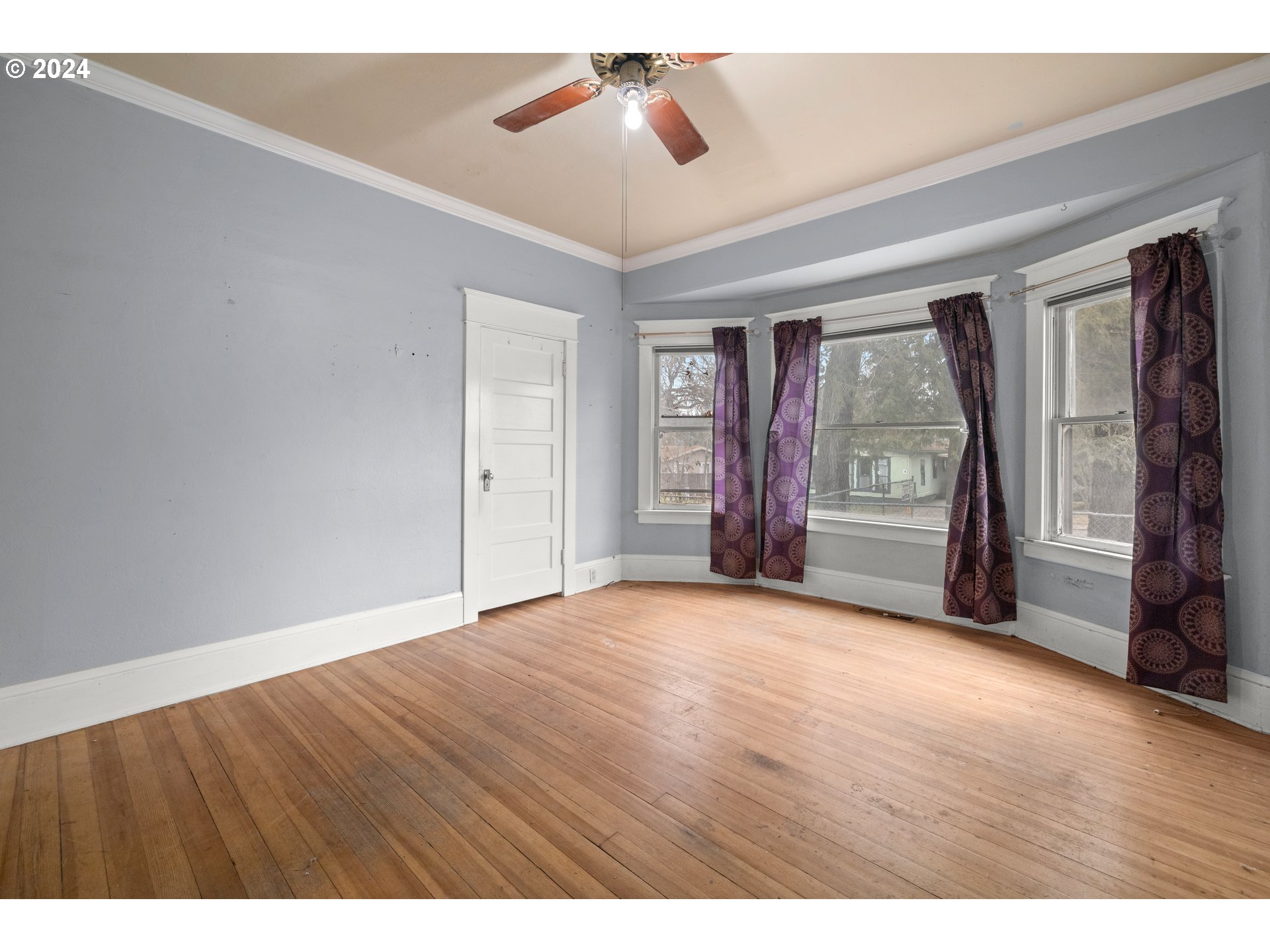 13049 Southeast Foster Road Portland, OR 97236 - Photo 8 of 19 wooden floor in an empty room with a window