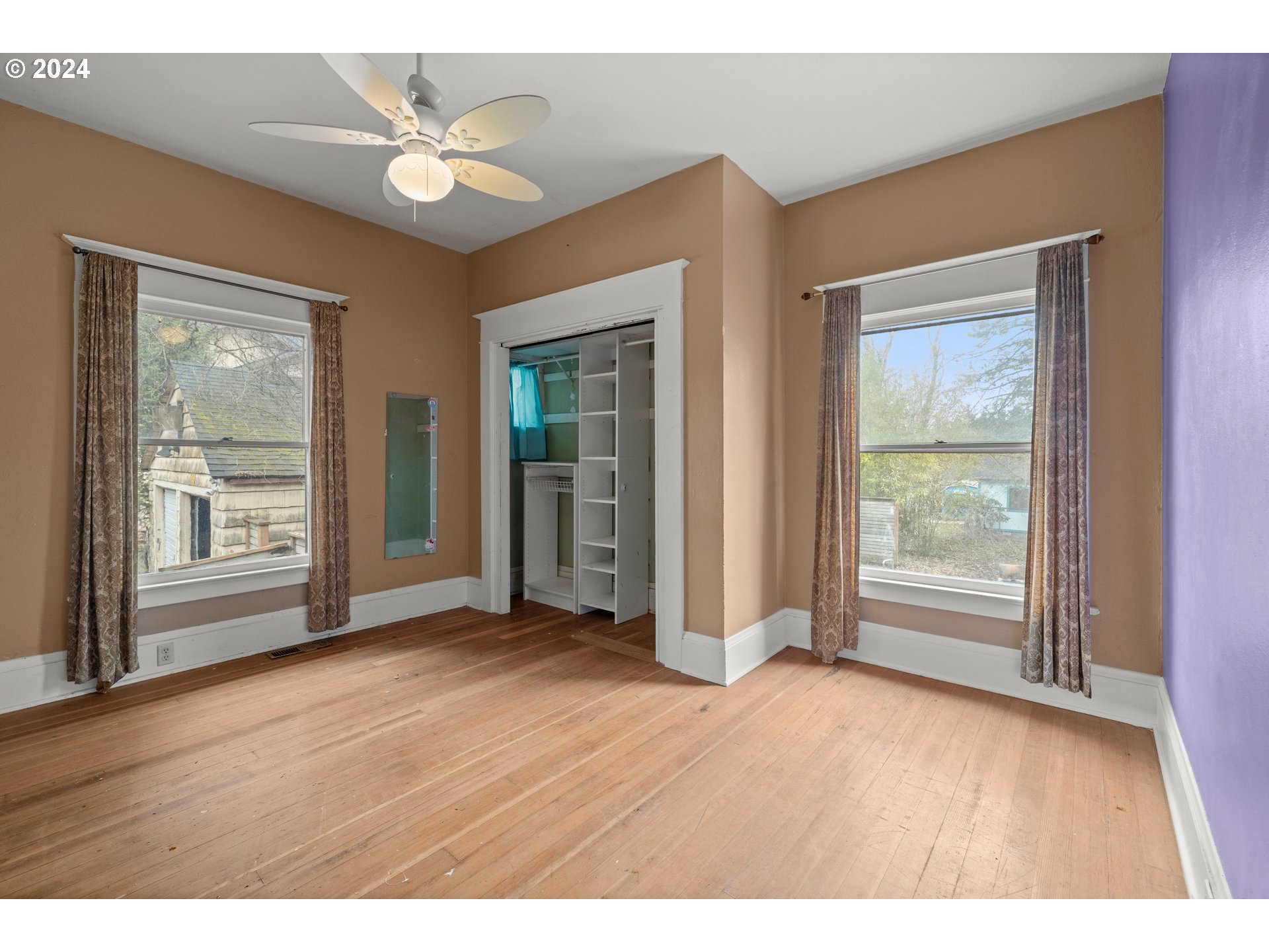 13049 Southeast Foster Road Portland, OR 97236 - Photo 9 of 19 a view of an empty room with wooden floor and a window