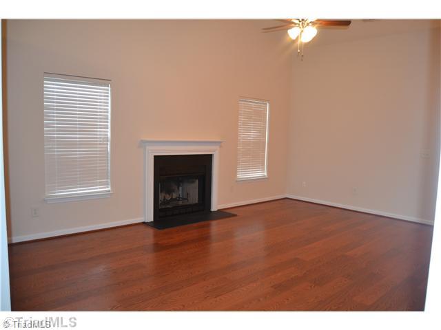 2787 WaterStone Loop High Point, NC 27265 - Photo 2 of 16 Living Room. Living room with new laminate flooring and vaulted ceilings. Fireplace.