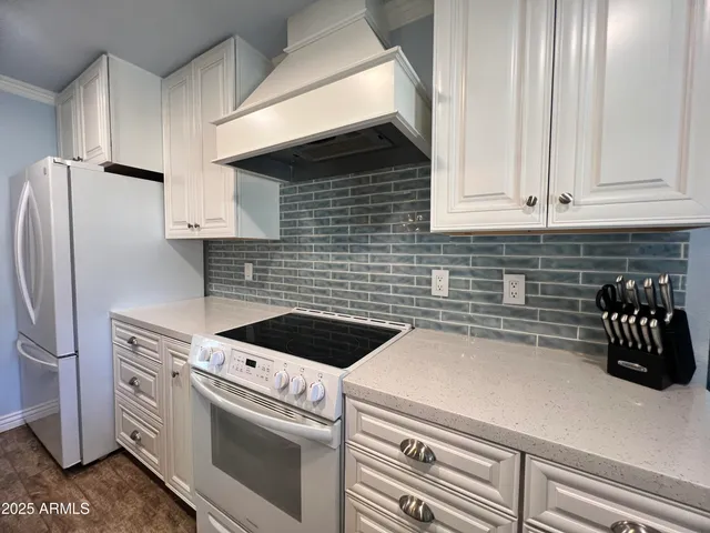 a kitchen with a white cabinets and white appliances