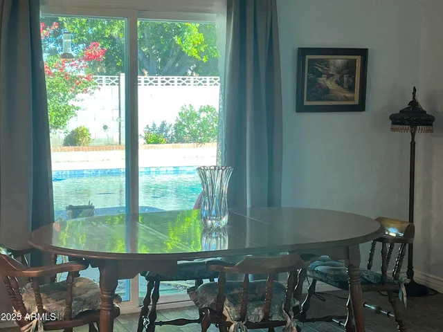 a view of a dining room with furniture window and outside view