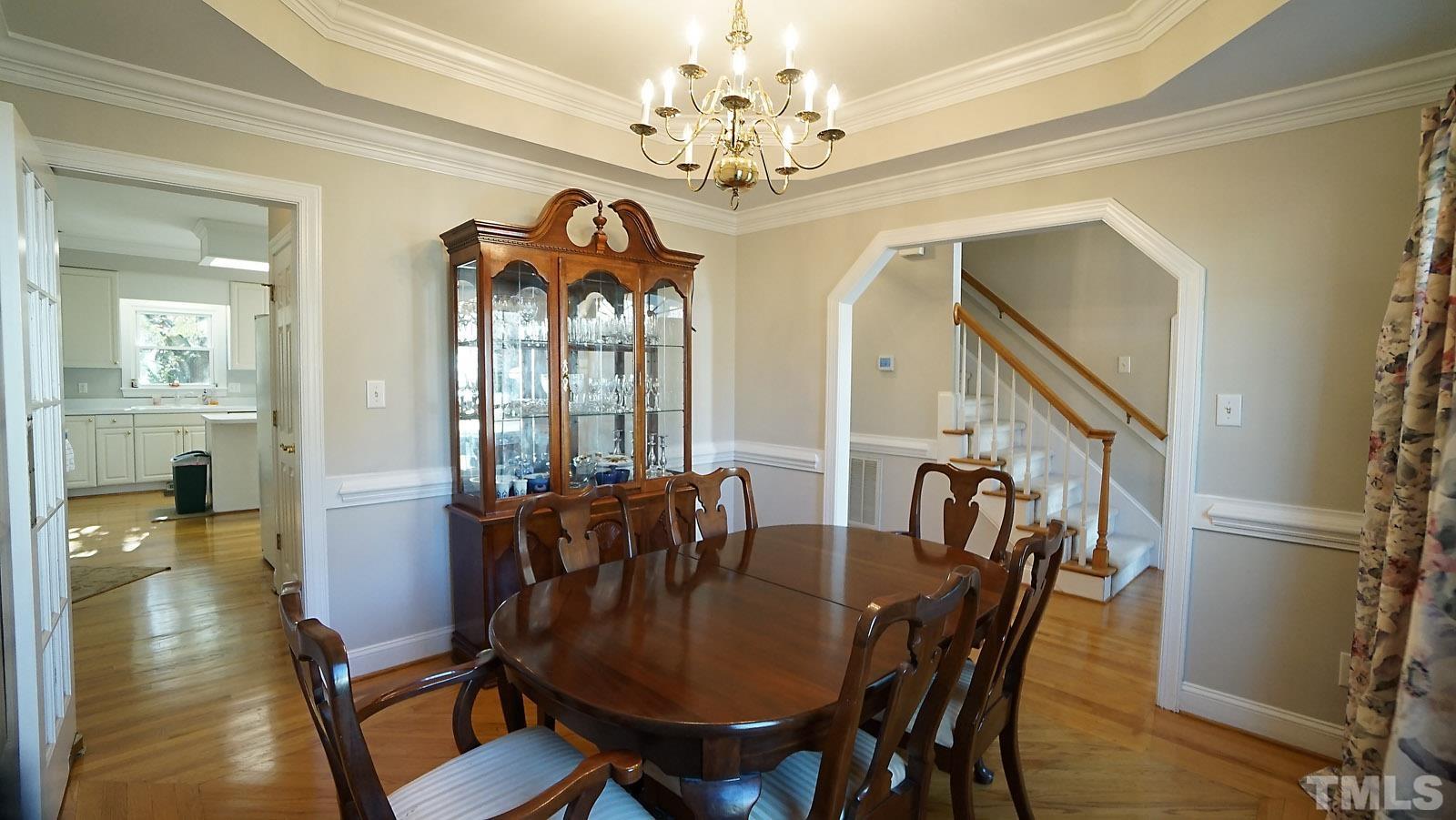 2701 Rydal Court Raleigh, NC 27613 - Photo 8 of 24 a view of a dining room with furniture wooden floor and chandelier