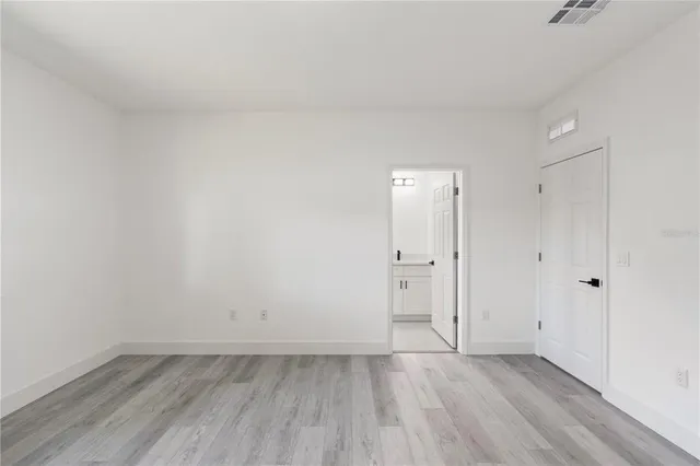 a view of an empty room and wooden floor