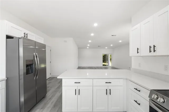 a kitchen with cabinets and stainless steel appliances