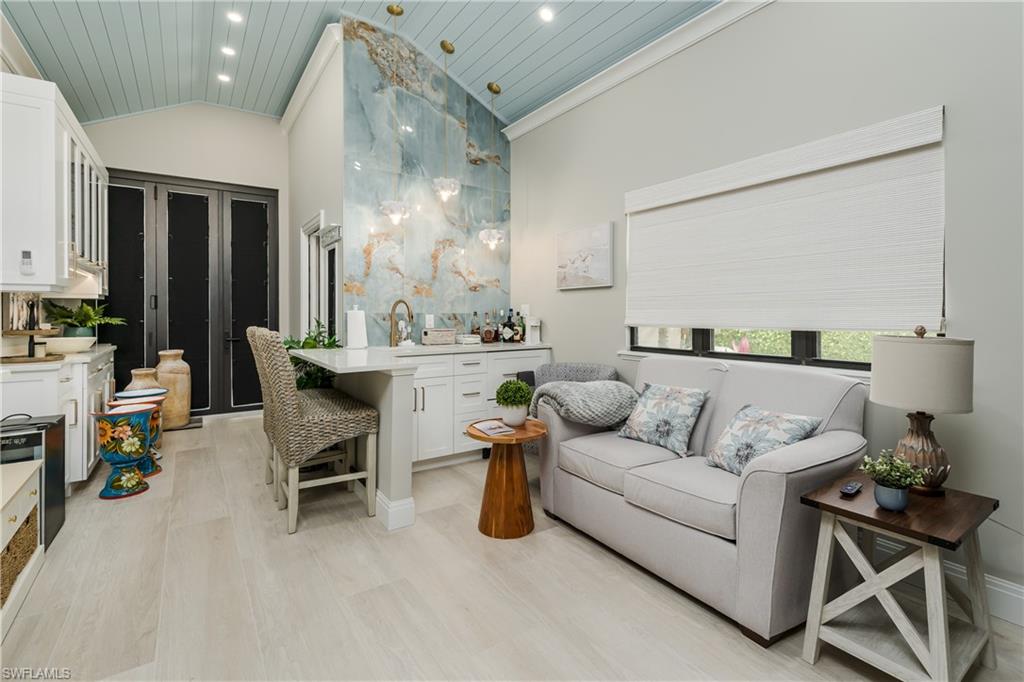 13613 Snapper Lane Naples, FL 34114 - Photo 12 of 49 a living room with furniture and a mirror