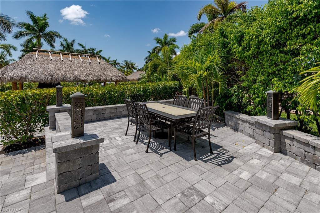 13613 Snapper Lane Naples, FL 34114 - Photo 20 of 49 a view of a tables and chairs in a patio