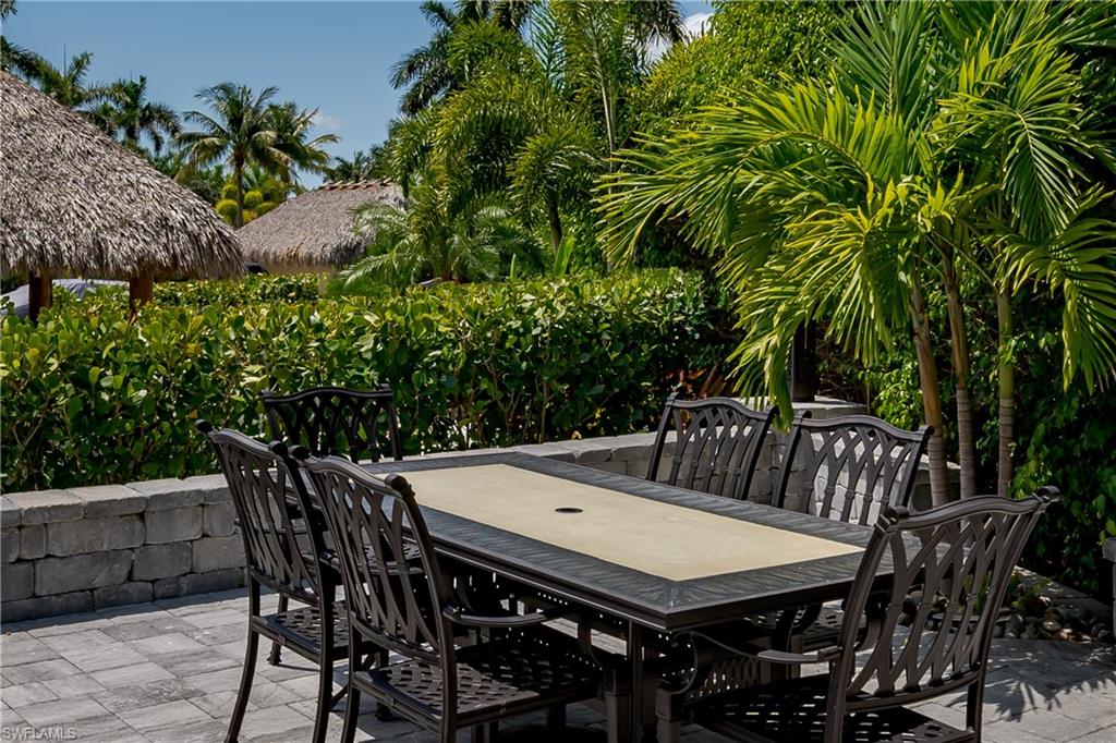 13613 Snapper Lane Naples, FL 34114 - Photo 21 of 49 a view of a dinning table and chairs in patio