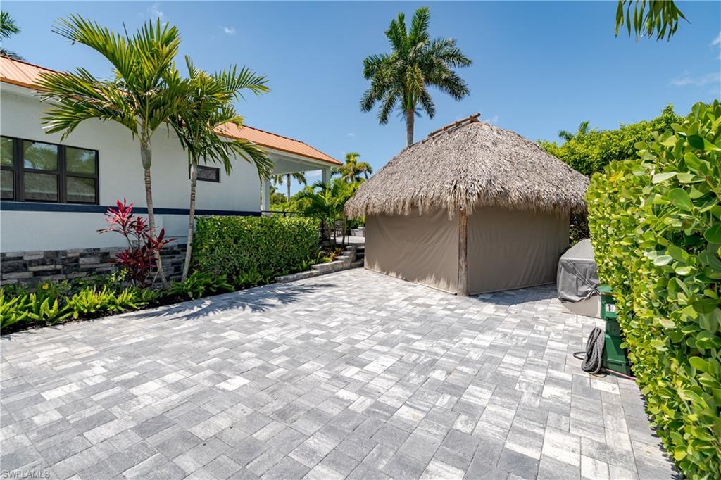 13613 Snapper Lane Naples, FL 34114 - Photo 26 of 49 a plant in front of a house with potted plants