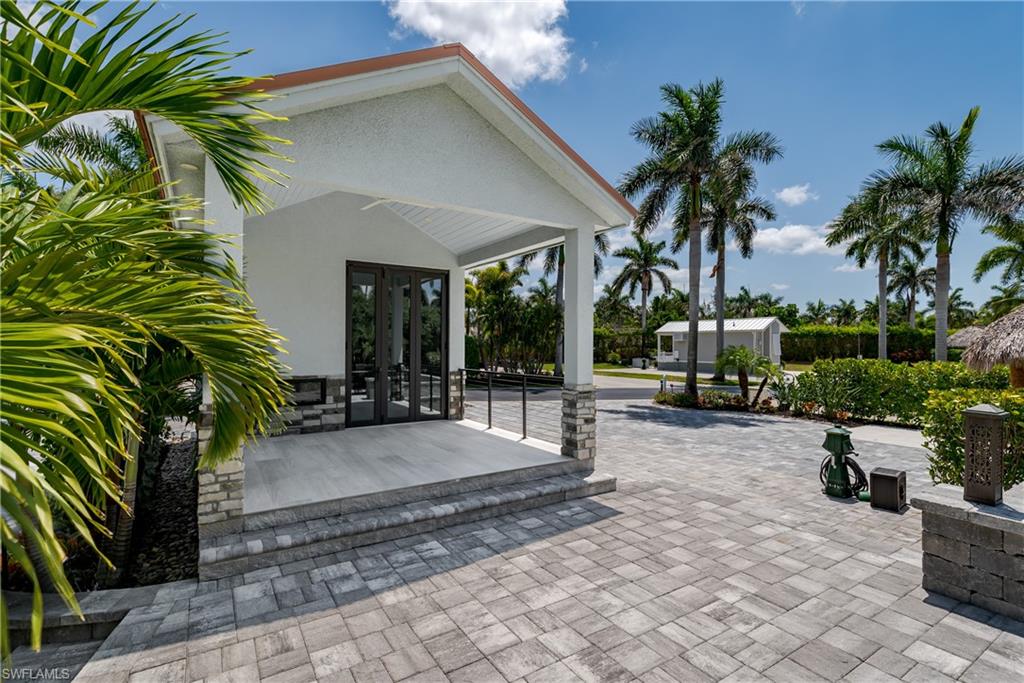 13613 Snapper Lane Naples, FL 34114 - Photo 3 of 49 a view of a backyard with plants and a patio