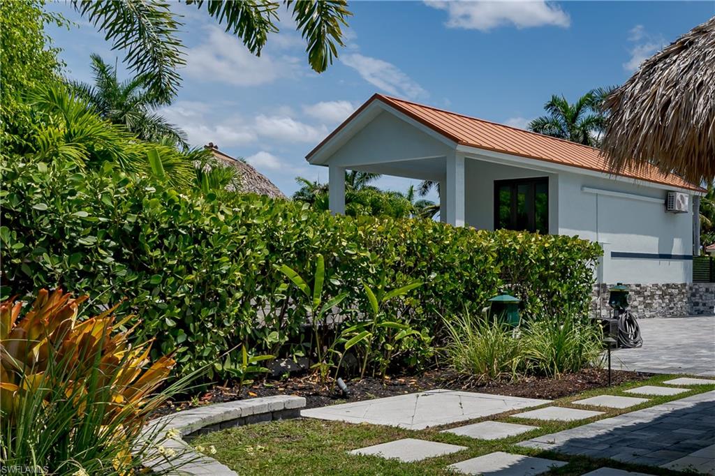 13613 Snapper Lane Naples, FL 34114 - Photo 38 of 49 a view of a house with a yard