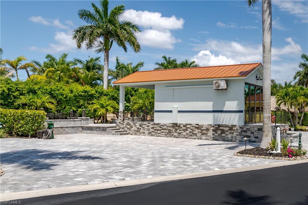 13613 Snapper Lane Naples, FL 34114 - Photo 40 of 49 a front view of a house with a yard and garage