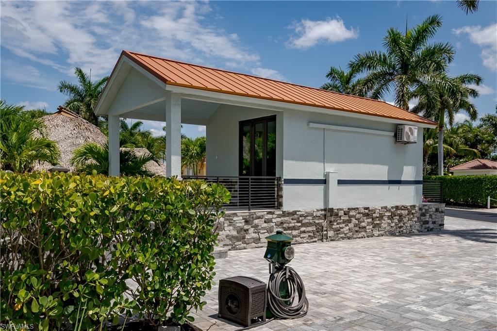 13613 Snapper Lane Naples, FL 34114 - Photo 4 of 49 a front view of a house with a yard