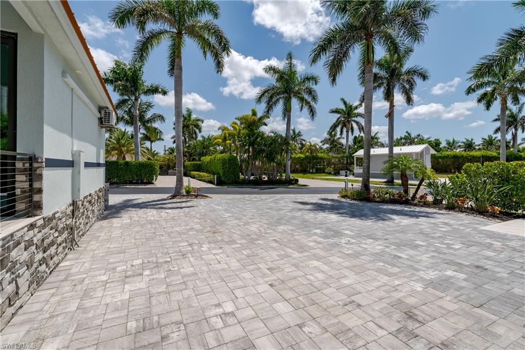13613 Snapper Lane Naples, FL 34114 - Photo 41 of 49 a view of a park with a bench and palm trees