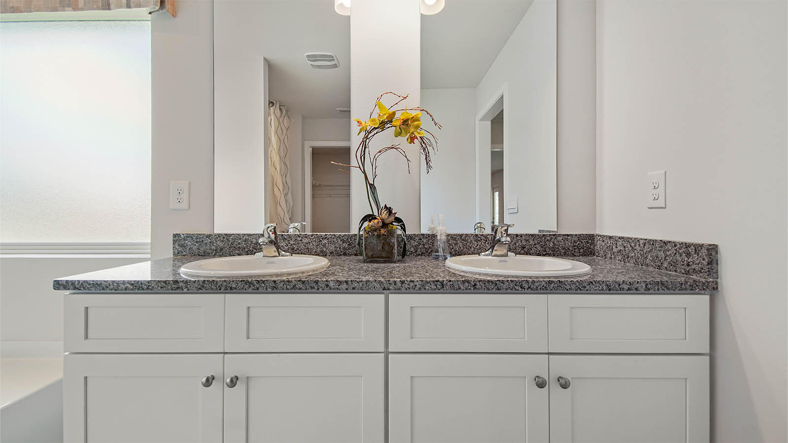 31 Riverwalk Circle Freeport, FL 32439 - Photo 20 of 38 a bathroom with a granite countertop sink and white cabinets