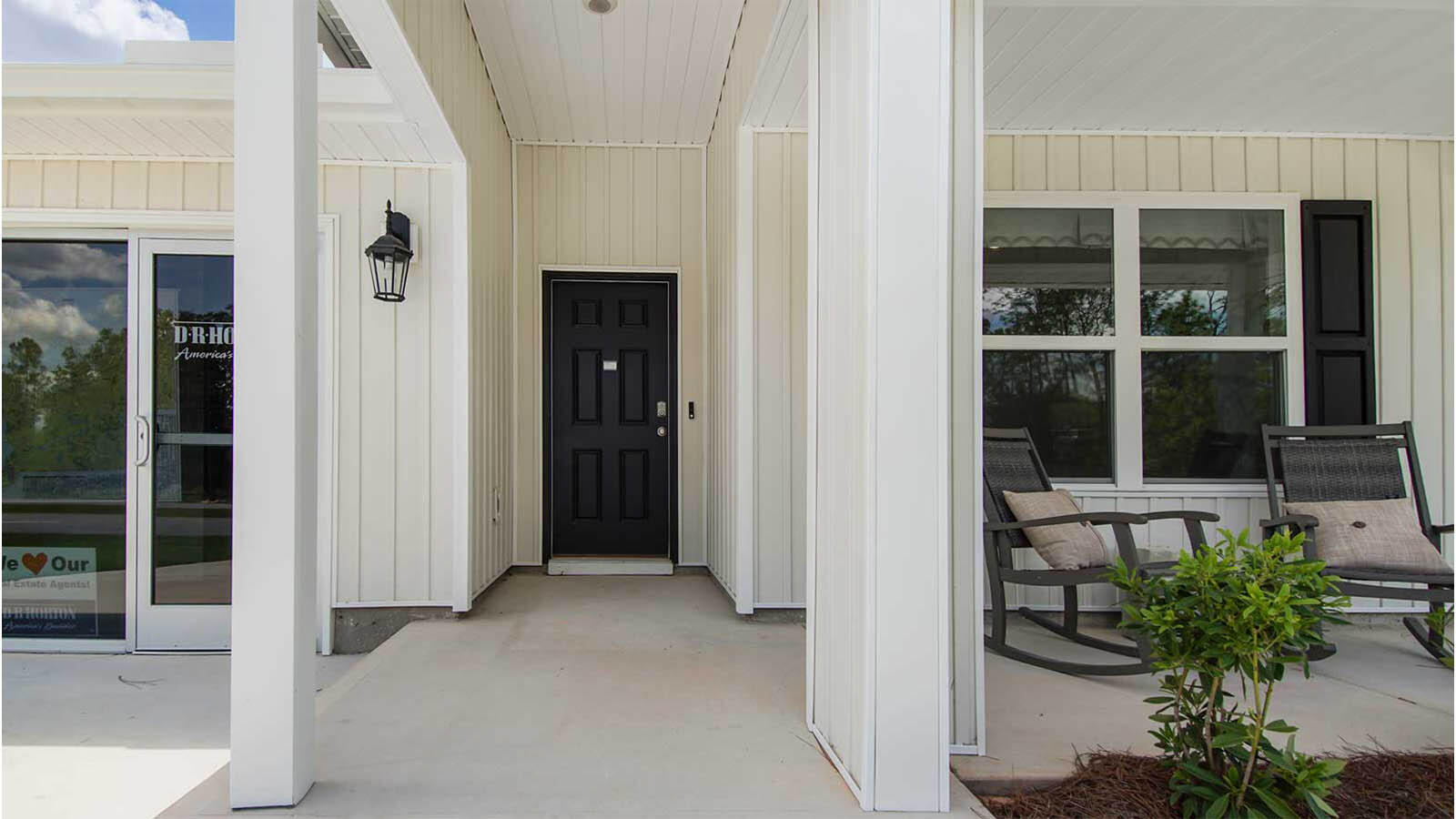 31 Riverwalk Circle Freeport, FL 32439 - Photo 2 of 38 a house with potted plants in front of door