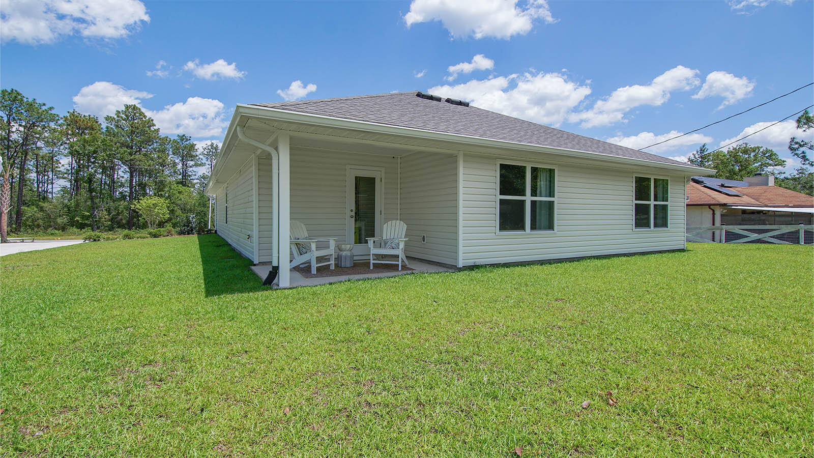 31 Riverwalk Circle Freeport, FL 32439 - Photo 37 of 38 a backyard of a house with table and chairs
