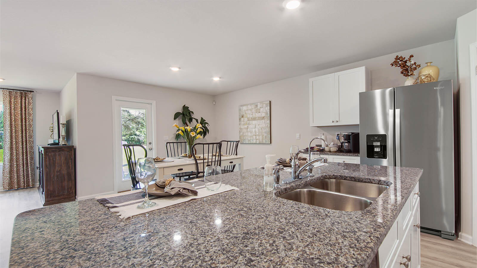 31 Riverwalk Circle Freeport, FL 32439 - Photo 6 of 38 a kitchen with stainless steel appliances granite countertop a sink refrigerator and cabinets