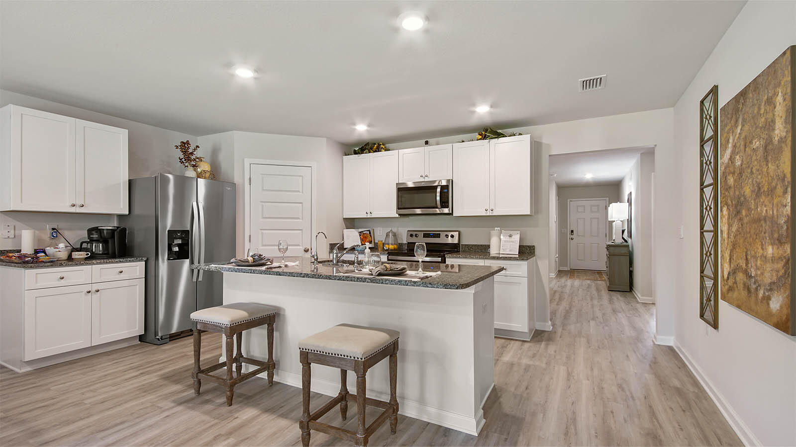 31 Riverwalk Circle Freeport, FL 32439 - Photo 8 of 38 a kitchen with white cabinets and stainless steel appliances