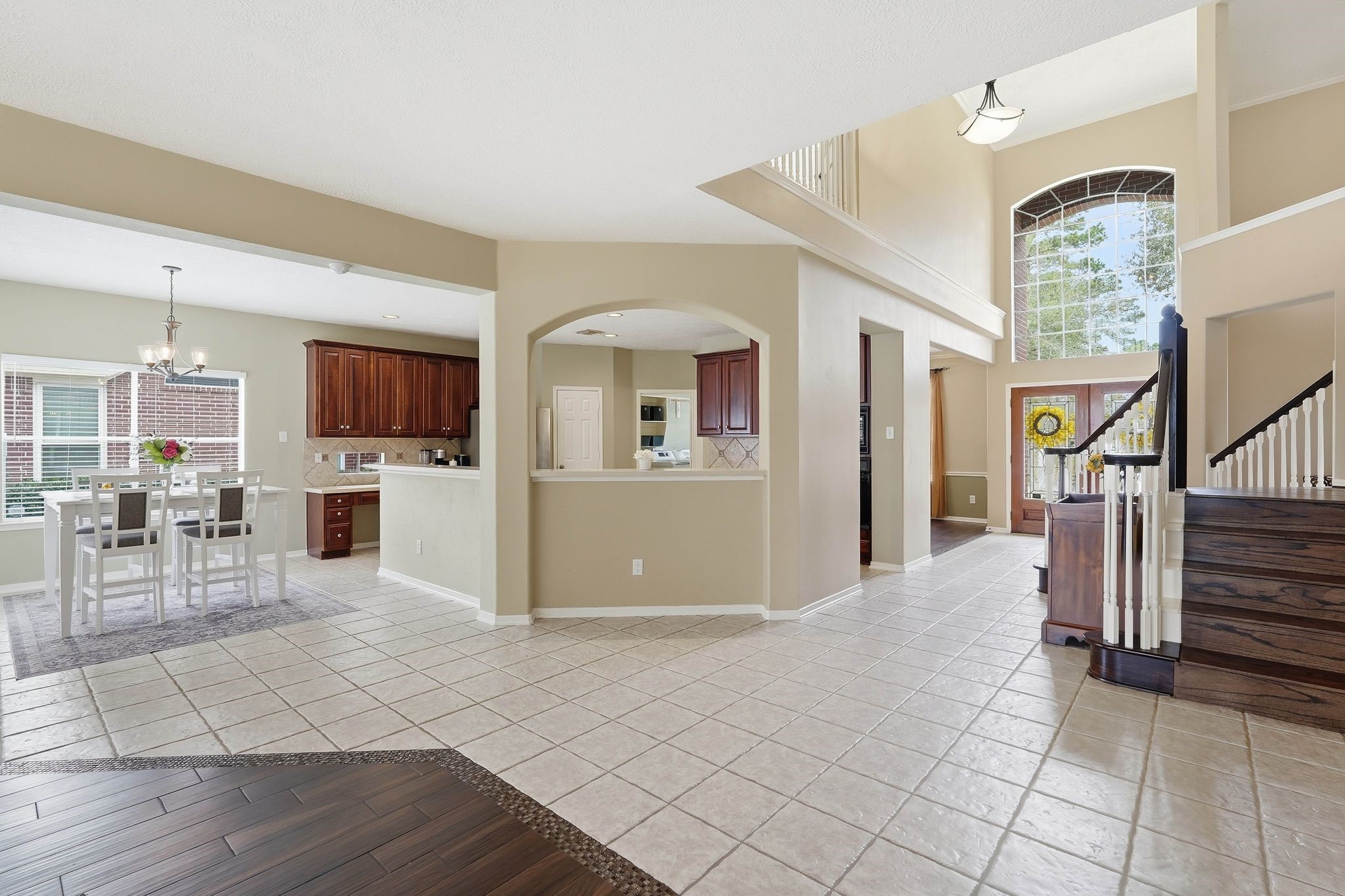 2515 Woodsboro Drive Spring, TX 77388 - Photo 17 of 44 This spacious entryway features high ceilings and large windows for ample natural light. The open layout seamlessly connects the living area, dining room, and kitchen creating a warm and inviting atmosphere.