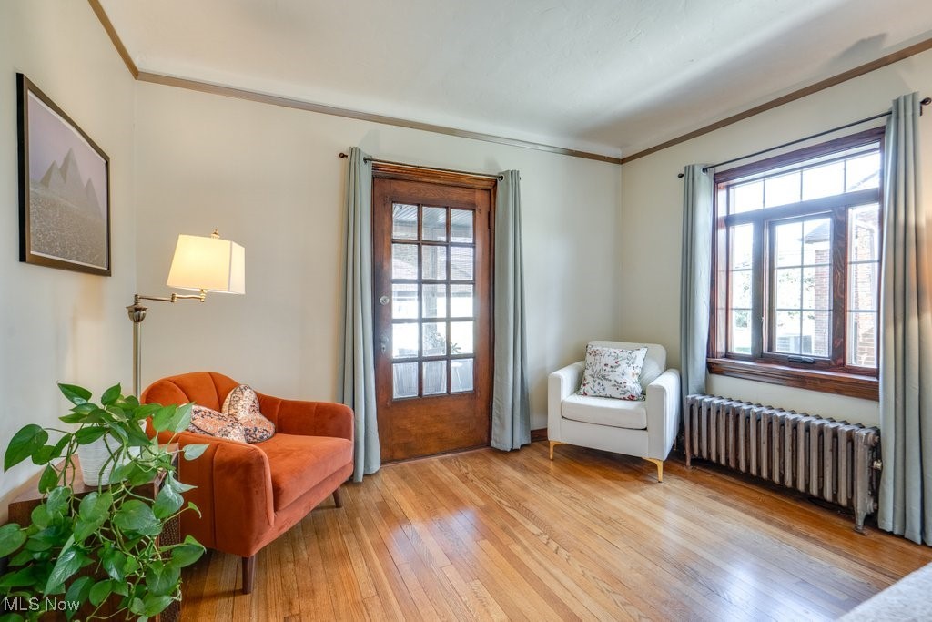 3849 Faversham Road Cleveland, OH 44118 - Photo 6 of 44 Living area with radiator heating unit, hardwood / wood-style flooring, crown molding, and plenty of natural light