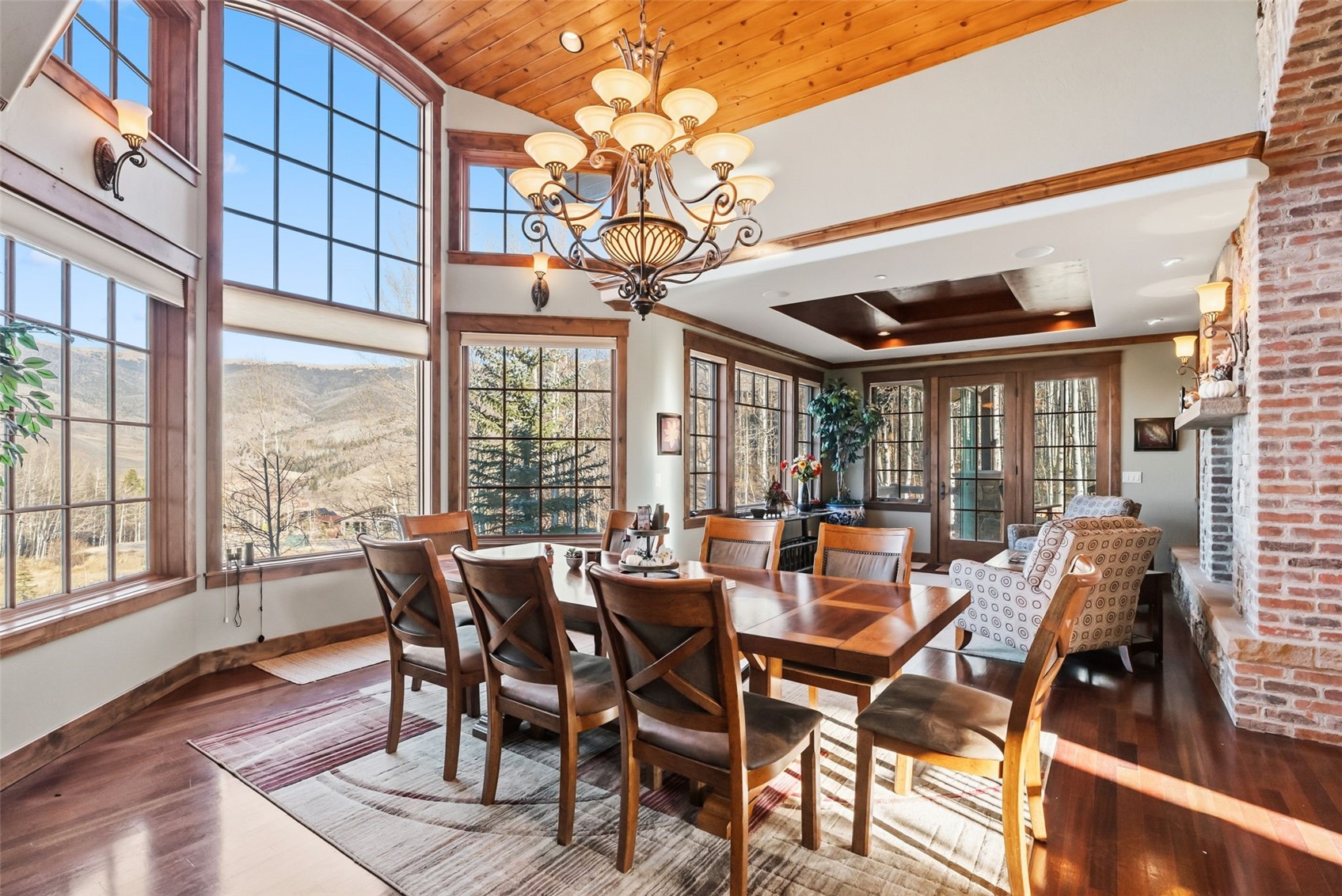 2140 Hunter's Knob Road Silverthorne, CO 80498 - Photo 4 of 46 Dining area featuring a chandelier, wood finished floors, a mountain view, wood ceiling, and vaulted ceiling