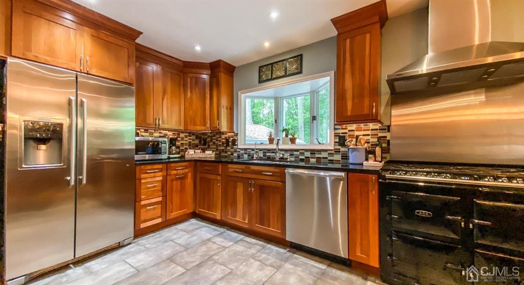 32 Huntington Road Edison, NJ 08820 - Photo 14 of 34 a kitchen with stainless steel appliances granite countertop a stove a sink and a refrigerator