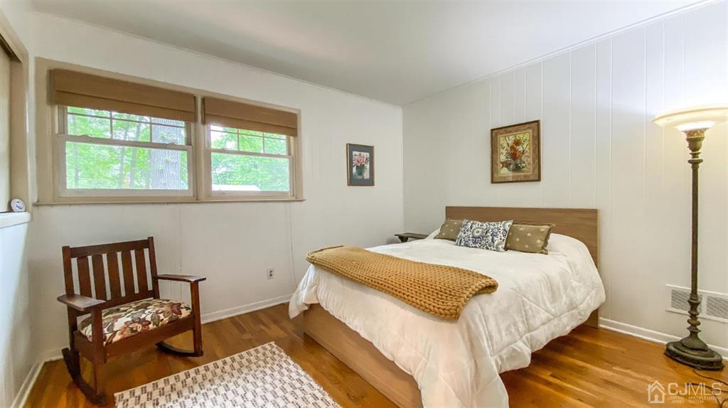 32 Huntington Road Edison, NJ 08820 - Photo 20 of 34 a bedroom with a bed and wooden floor