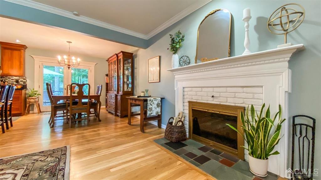 32 Huntington Road Edison, NJ 08820 - Photo 8 of 34 a living room with furniture a fireplace and potted plants with wooden floor