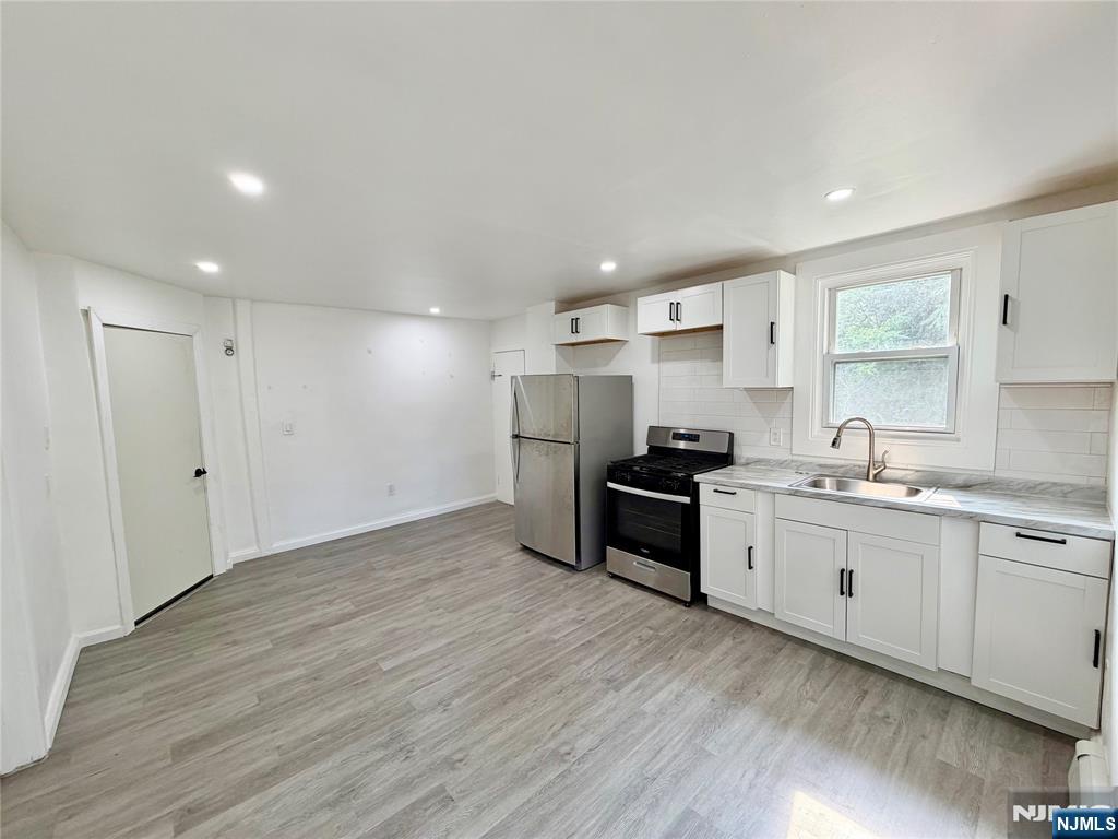390-apt 5 Orange Road, Unit 5 Montclair, NJ 07042 - Photo 4 of 12 a kitchen with stainless steel appliances granite countertop a sink stove and refrigerator