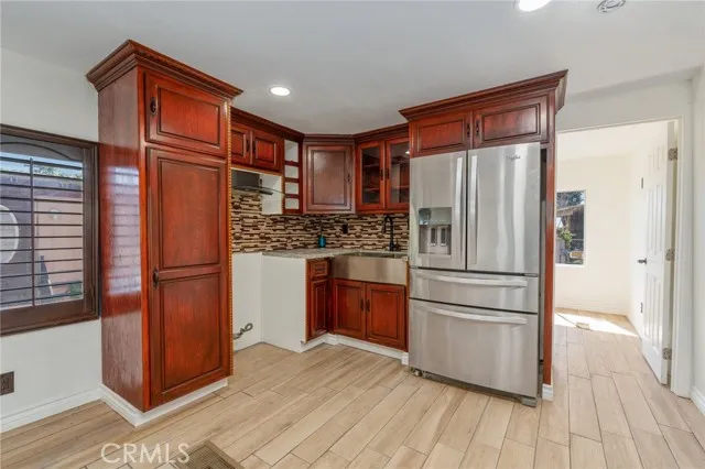 3319 Avalon Street, Unit 33 Riverside, CA 92509 - Photo 1 of 1 a kitchen with stainless steel appliances a refrigerator and wooden floor