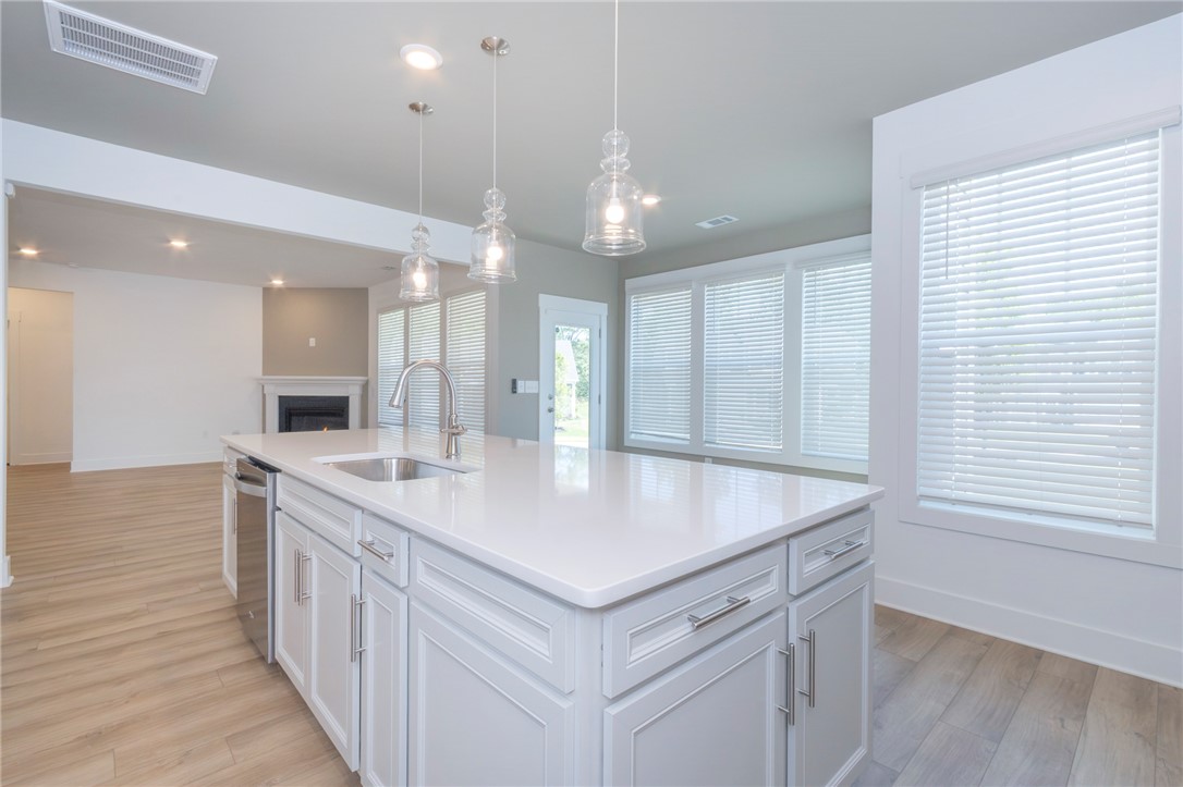 607 WH Kay Lane Anderson, SC 29621 - Photo 10 of 48 A well-lit kitchen island with gleaming counters anchors this open-concept living space.