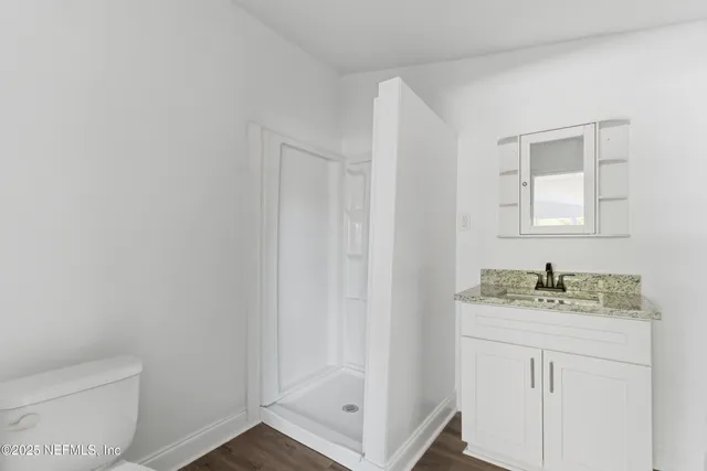 a view of a kitchen with wooden floor
