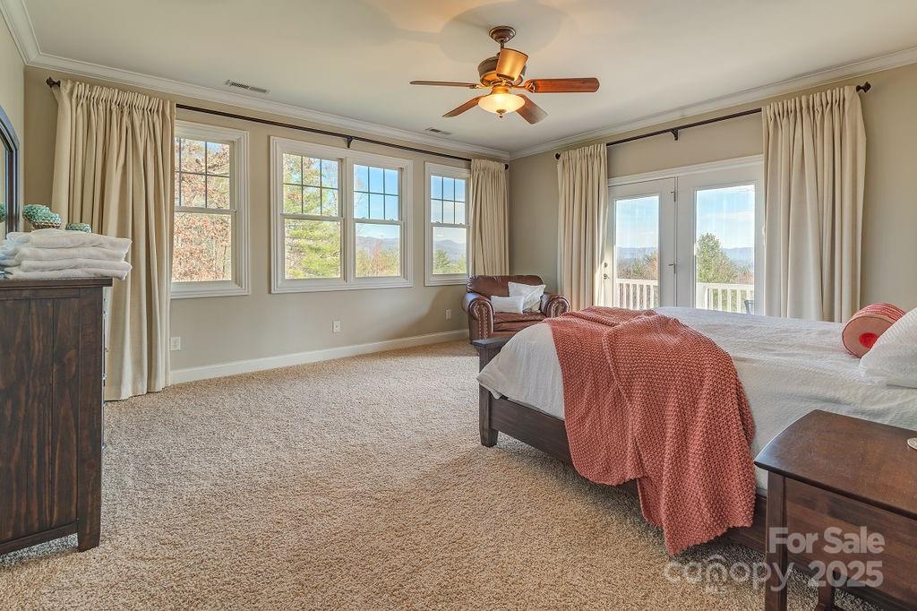 61 Buckle Ridge Weaverville, NC 28787 - Photo 15 of 42 a spacious bedroom with a bed and a chandelier