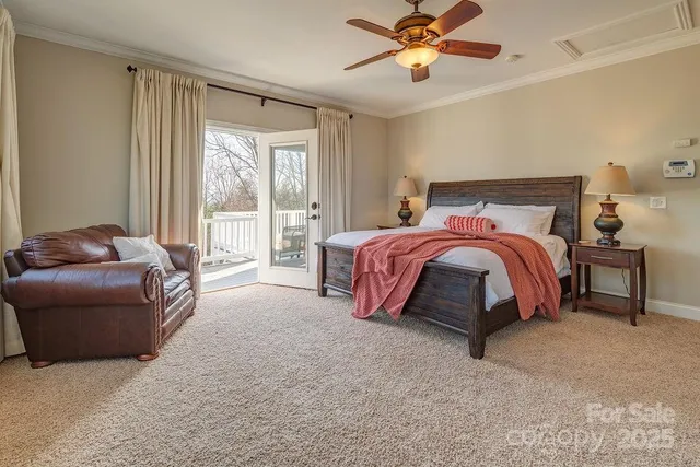 a spacious bedroom with a bed and a chandelier