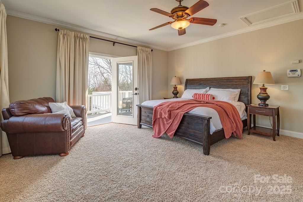 61 Buckle Ridge Weaverville, NC 28787 - Photo 17 of 42 a spacious bedroom with a bed and a chandelier