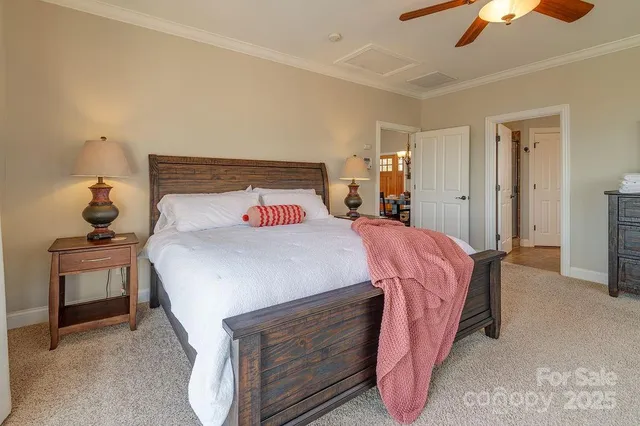 a bed sitting in a bedroom and night stand