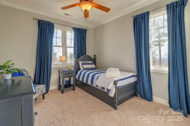 a spacious bedroom with a large bed and a chandelier