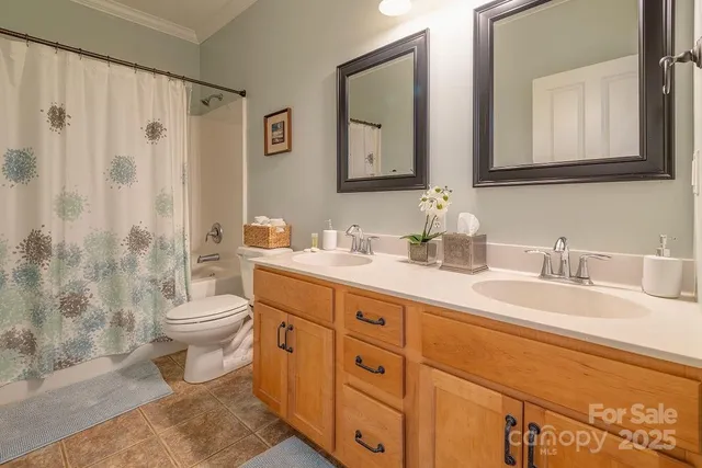 a bathroom with double sink and a mirror