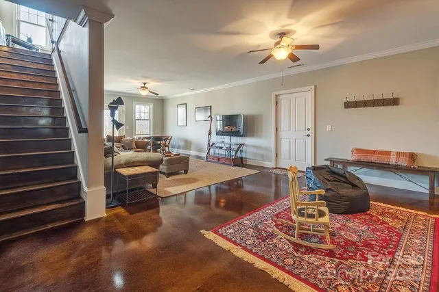 a living room with furniture and a chandelier