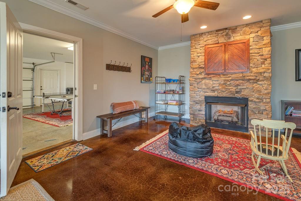 61 Buckle Ridge Weaverville, NC 28787 - Photo 25 of 42 a living room with furniture a fireplace and a chandelier