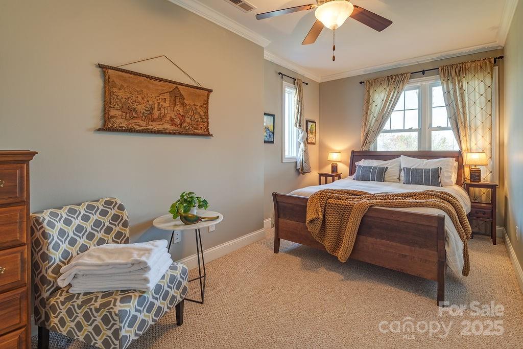 61 Buckle Ridge Weaverville, NC 28787 - Photo 31 of 42 a bedroom with a bed and ceiling fan